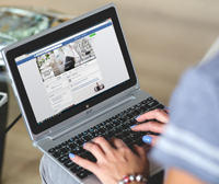 hands-woman-laptop-facebook