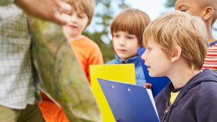 kids doing a treasure trail fun things to do in sussex this half term - article for title sussex www.titlesussex.co.uk