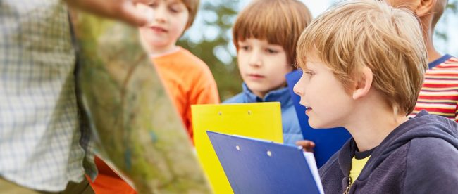 kids doing a treasure trail fun things to do in sussex this half term - article for title sussex www.titlesussex.co.uk