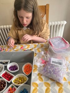 Rosie Sullivan sat with her beads making the bracelets.
