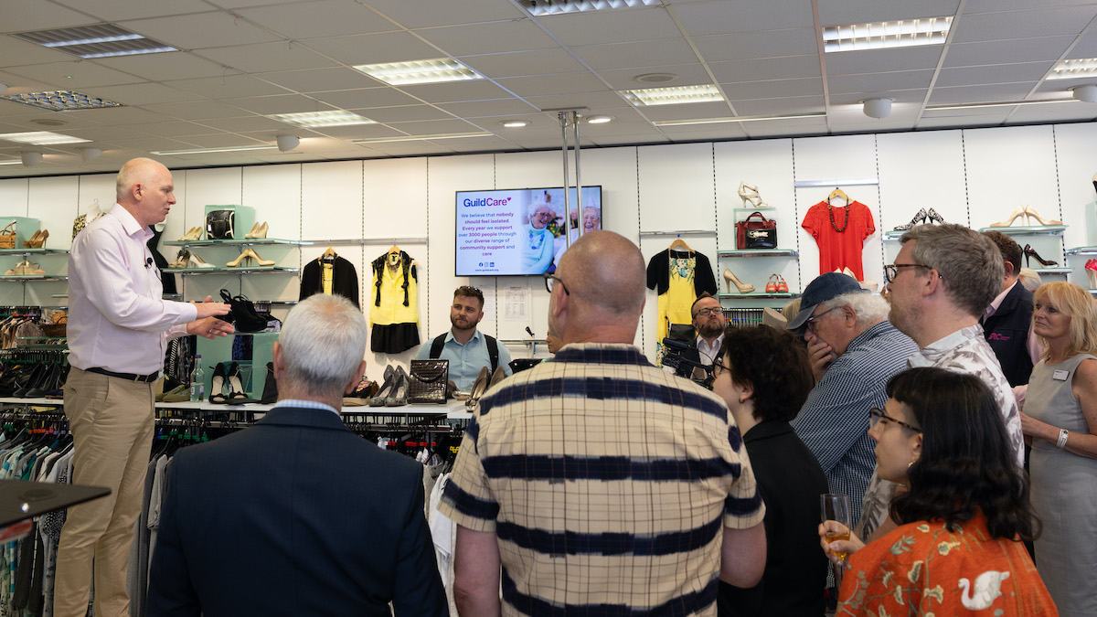 People crowded round listening to Alex Brooks-Johnson presentation.