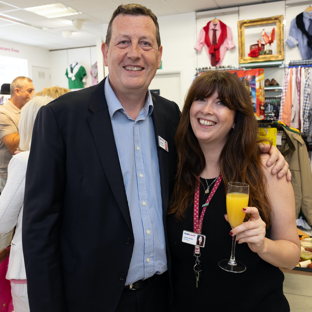A man and woman, who both work for Guild Care, standing in the Guild Care shop.
