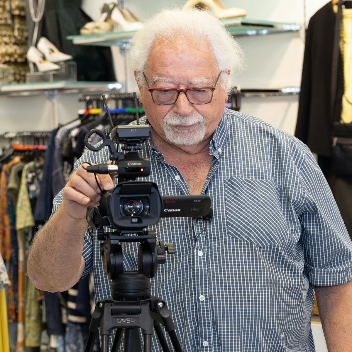 Mike Mendoza, Tv latest, holding a camera in the shop.