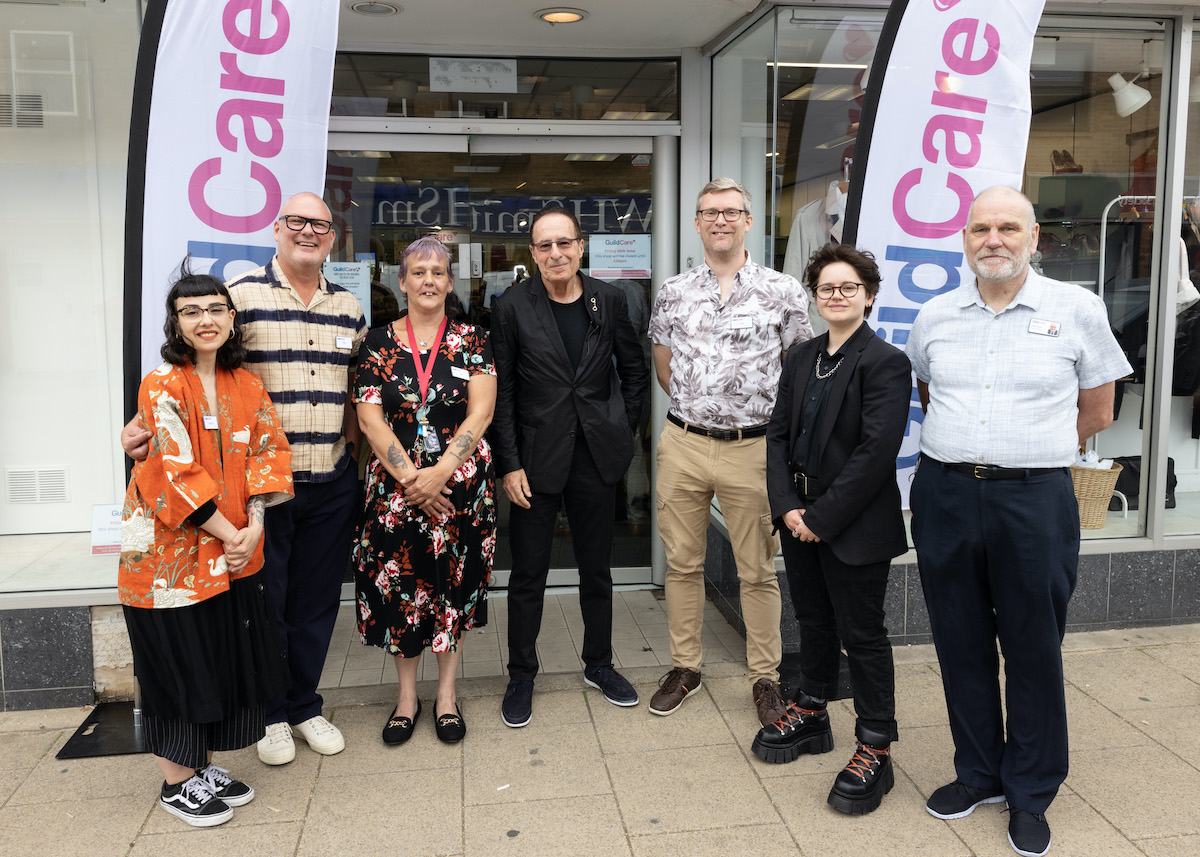 Peter James standing with members of Guild Care.