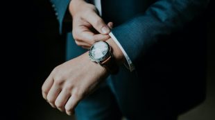 Image shows a close up of a man's wrist with a fancy watch on