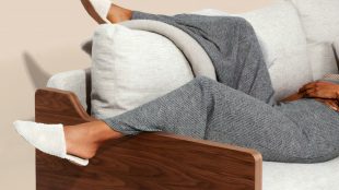 Image shows a woman's legs relaxing on the sofa, her face is out of shot
