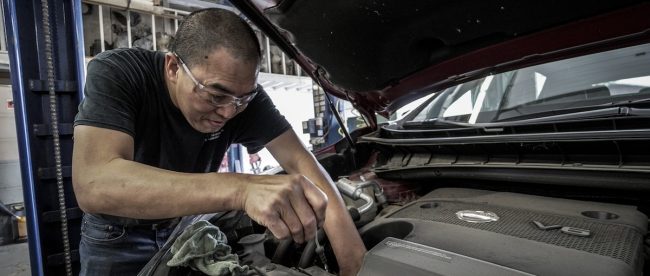 man working on car for basic car maintenance for title sussex titlesussex.co.uk
