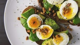 avocado and egg on bread with leafy greens