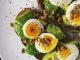 avocado and egg on bread with leafy greens